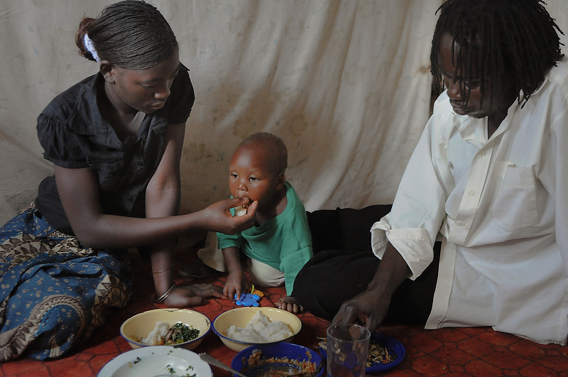 Tasila, partner Nicholas, and her son Felix eat lunch on October 4, 2010.